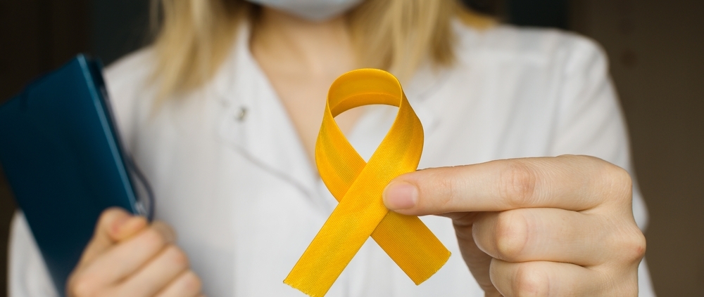 Doctor holding a yellow ribbon