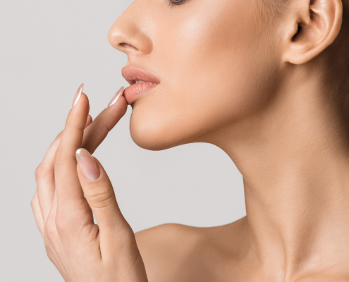 woman applying lip balm to cure her angular cheilitis