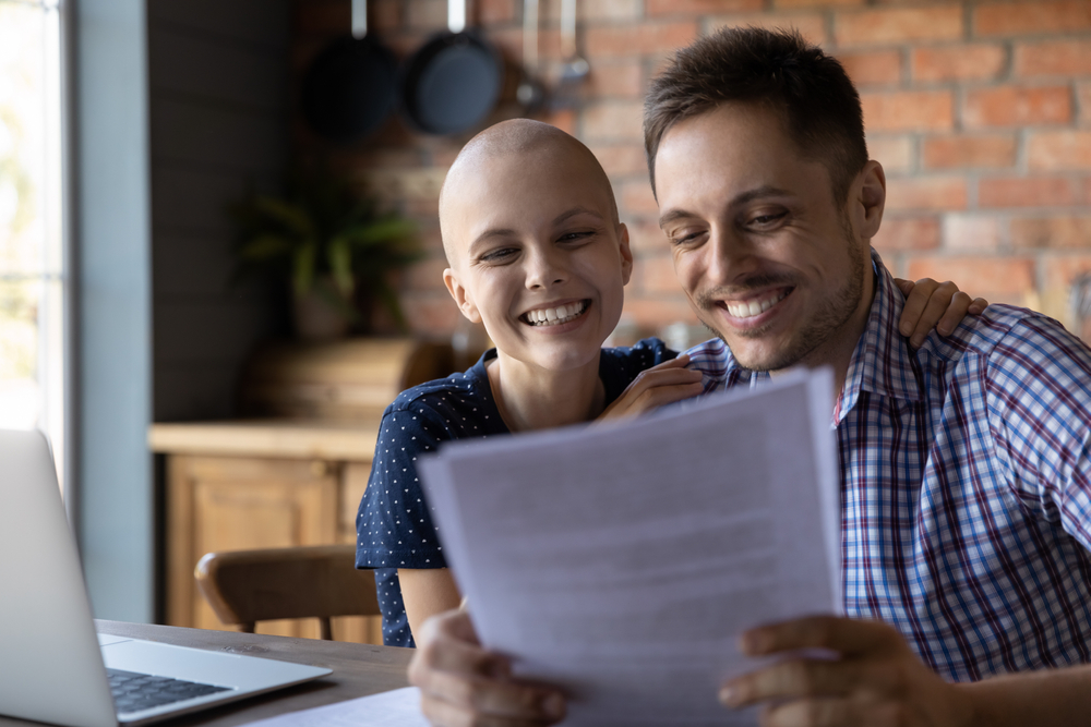 cancer patient and partner are looking at some documents