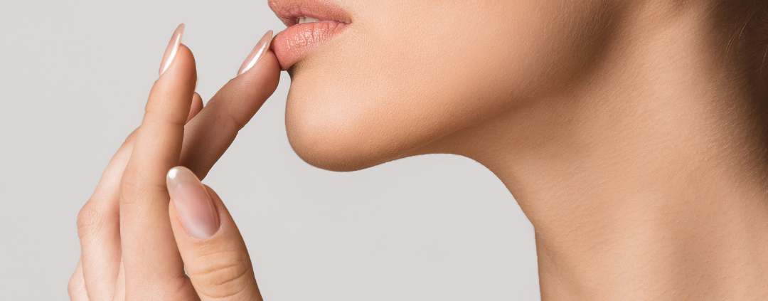 woman applying lip balm to cure her angular cheilitis